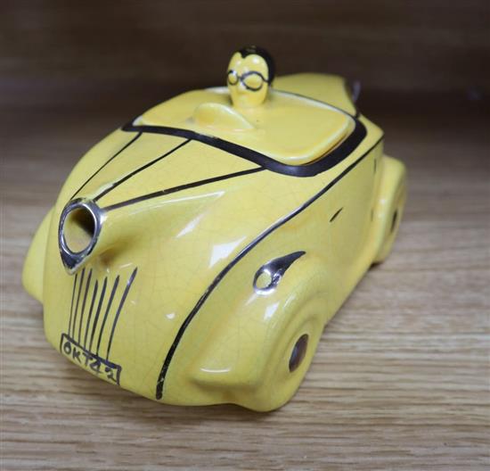 A Sadlers yellow glazed racing car teapot and cover, with silver lustre detail, registration OKT42